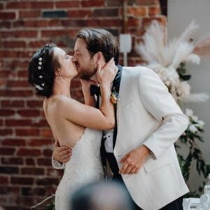 Erin and Will kissing at their wedding reception